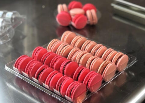 Light and dark pink macarons in tray